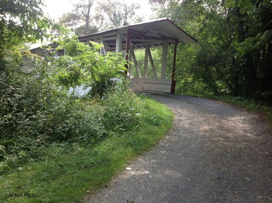 13.606 ACRES OF MOSTLY WOODED LAND IN PICTURESQUE BEDFORD COUNTY PA.WITH YEAR AROUND ACCESS VIA HISTORIC TURNER COVERED BRIDGE,THIS UNIQUE PROPERTY IS A FISHERMANS DELIGHT FEATURING APPROXIMATELY 500' OF RIVER FRONT ALONG THE RAYSTOWN BRANCH OF THE JUNIATA RIVER.GREAT HUNTING ,FISHING AND RECREACTIONAL PROPERTY.LOCATED WITHIN MINUTES FROM SHAWNEE STATE PARK ,OLD BEDFORD VILLAGE AND OTHER LOCAL HISTORIC ATTRACTIONS, SUB SURFACE MINERAL RIGHTS ARE INCLUDED WITH THE LAND.