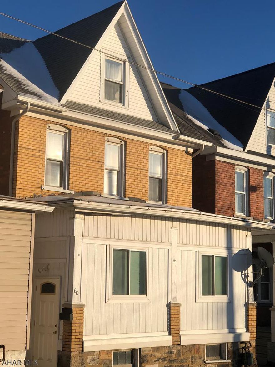 Large brick home with off-street parking and fenced rear yard. This 3-4 bedroom home has an enclosed rear porch for 1st floor laundry and updated vinyl wood-look flooring throughout main floor. The front porch has been enclosed and opened to the living room. The second floor is home to 3 bedrooms. 1 of the bedrooms is being used as a walk-in closet. The 3rd floor can be updated to make a 4th bedroom. The heat source is approximately 7 years old, newer 100 amp electric panel. This home also has a security system and 1 year home warranty.