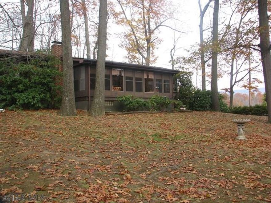 This is a very well cared for home on a quiet dead end street.  A beautiful sunroom has been added on to enjoy the nature and quiet of this neighborhood. The lower level has a large family room with a wood burner.   Home sits on over an acre which is hard to find in the city limits.  There is plenty of room to use the current home as a rental and build your dream home if you wish.  Currently it is septic but public sewer is available. A new 250 gallon oil tank was just installed.  Electrical has been updated as well as a water filtration system that is about as pure as it can get.