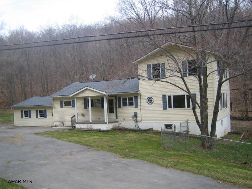 2 Story vinyl Bellwood Antis home on over 1/2 acre in need of major TLC.  . Large living room, beautiful eat-in kitchen with breakfast bar and dining area, 3 first floor bedrooms and bath, plus large 2nd floor Master Suite with full bath and walk-in closet. 2 car attached garage, large fenced yard and wild trout stream off back yard. Property sold AS-IS. Seller will make no repairs. Offers must be submitted through HUD approved broker. Buyer pays both transfer taxes. Equal Housing Opportunity.