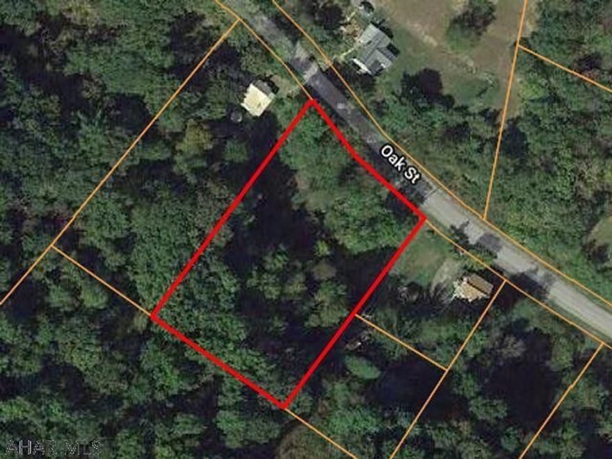 Partially wooded lot with stream. Sewer tap to property. Call listing agent for details.