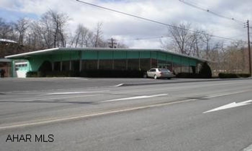 Good location for this commercial building. Interior showroom, offices and warehousing. Property is being sold AS IS.