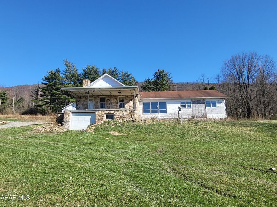 Welcome to Antis Township, where rarity meets opportunity! Nestled on an expansive 50 acres of pristine land and surrounded by large land tracts, this property offers a once-in-a-lifetime chance to own a piece of paradise.  Prepare to be enchanted by the breathtaking views from this secluded sanctuary. With its unparalleled privacy, this location invites you to immerse yourself in the beauty of nature.  Gracing this remarkable landscape are two stone-cut homes, each with its own unique character. The main residence boasts four bedrooms and three baths, all on the main floor that tops a walk-out basement and is complete with a convenient one-car garage. Adjacent to it stands a three-bedroom, one-bath dwelling. While both homes are treasures waiting to be polished, they offer endless potential for those with vision and a passion for renovation.  Indeed, they may require some tender loving care, but these homes are like diamonds in the rough, just waiting to shine once again. And with 50 acres of land at your disposal, the possibilities are truly endless.  Remember, they're not making any more ground! Don't miss out on the chance to make this slice of heaven your own. Seize this opportunity to create your own legacy in Antis Township.