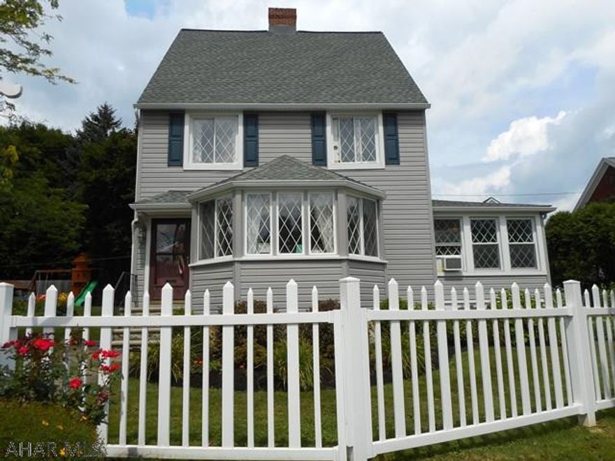 This charming 4 bedrm home sits on an over- sized,  fenced-in lot beautifully landscaped.. House and garage have been newly sided and  roofs replaced.    Living  rm has a stone fireplace and hardwood floor. lst floor family rm with access to a trek deck and stone patio. Formal dining rm with h/w floors and corner cupboard. Large eating area off the kitchen. 2nd floor has 3 bedrms and large hall closet. 3rd floor finished into a spacious, bright bedrm with large walk-in closet plus additional storage. Additional off street parking . Don' t miss this very special property!!