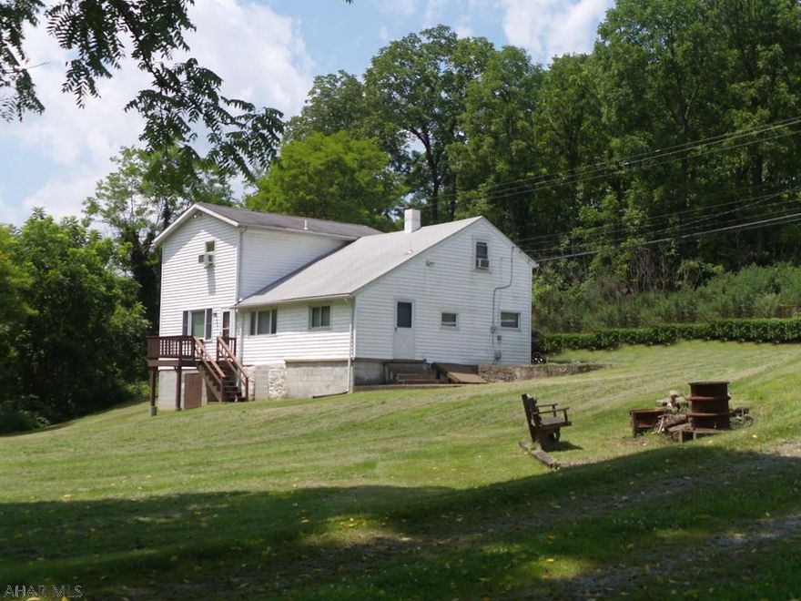 If you are looking for peace and quiet, space and privacy, don't miss this opportunity!  This home offers 3 - 4 bedrooms offers so many possibilities!  Use it as it is currently being used which is cabin style that will sleep 20 or so!  It can also easily be transformed into a single family home, or make money using it as an Airbnb!  It's location is within 30-45 minutes of Penn State games, Arts Fest, Raystown Lake and so many of our Central PA activities!  BONUS - IT IS BEING OFFERED FULLY FURNISHED!  Its turn-key to make money!  Fishing rights are not included, but walk along the banks of the Spruce Creek and enjoy the solitude!  This is a rare chance on 0.43 acres.