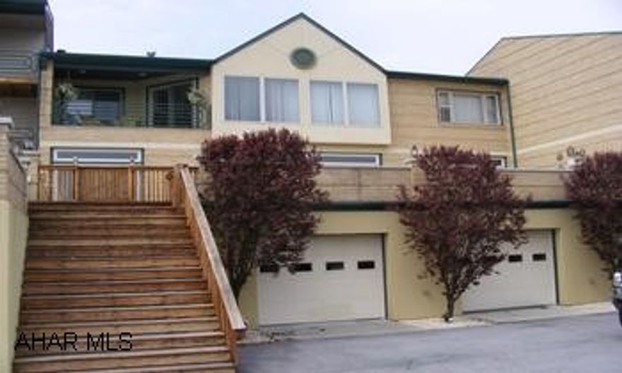 Spectacular view of lake and mountains. Very beautiful and unique condo. The upper level houses the gorgeous living room with see-through fireplace to master suite and private porch.  The kitchen opens to the living room w/wonderful views. Master suite features garden tub/jacuzzi and opens to private porch w/ mountain and lake views. 2nd level  21x50 is an absolutely terrific place for entertaining w/ its wonderful wet bar, diining area  and  kitchen w/ again mountain and lake views. 3rd level is again a beautiful family room 16x50 w/ wood ceilings,views and open to a huge patio..THIS IS A TRULY PEACEFUL HOME!   Call Ginny Erb @695-0629 for you showing.