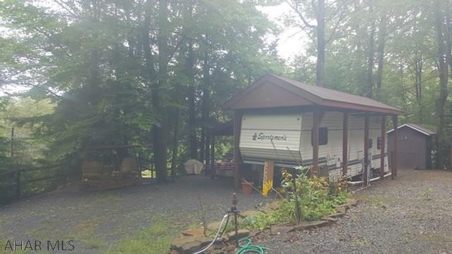 5th Wheel camper with cozy addition and lot for sale in Glendale Yearound. Camper is 32' long. Addition really gives you a lot more room to stretch. Camper and addition are under shingle roof. Glendale Yearound is gated community minutes away from Glendale Lake, Prince Gallitzin State Park, and Rock Run ATV Park. Shed also included with property.