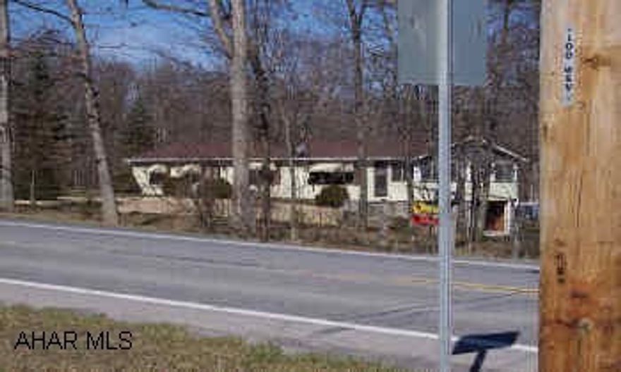 This charming,well kept 3 bedroom home has a newly remodled kitchen with light oak cabinets, bricked wall with fireplace in living room and sliding glass doors opens onto a roomy deck with a wooded view.