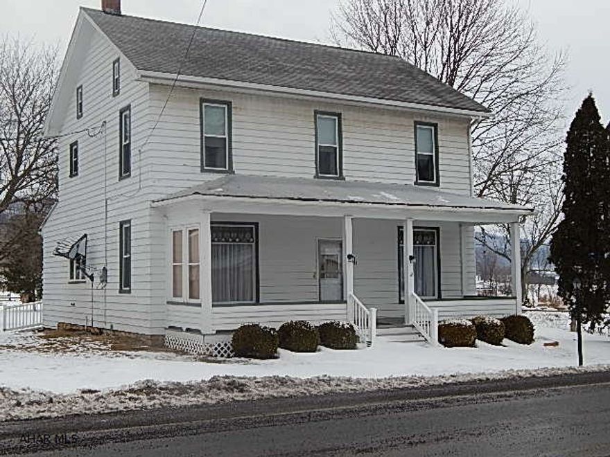 Large old farm house with lots of character. Large bedrooms, eat in kitchen, nice enclosed back porch with first floor laundry and 2 2 car garages and a large back yard with maintenance free deck!This property has a well but also comes with water rights to two springs located behind property!