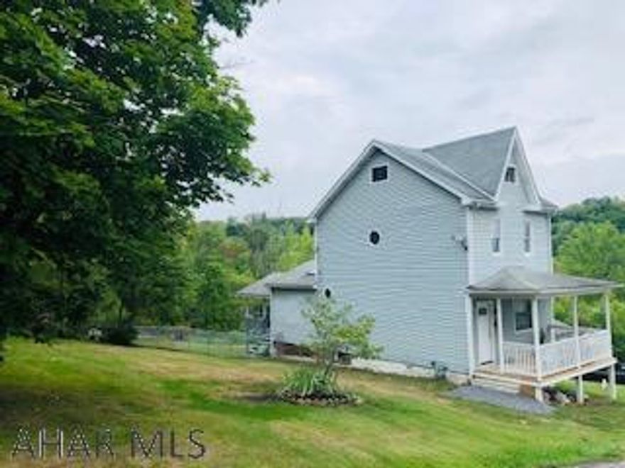2 bedroom home, Could make 3rd bedroom on 3rd floor. Large eat in kitchen, skylights and large windows. French door leading to covered deck. Fenced lot. Extra large 2 car detached garage. Work benches included. Property includes 2 parcels. Extra parcel is 01.13.19.084-00-000.