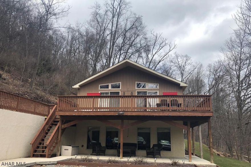 A stunning 3 bedroom, 2 bath gem nestled on 6.5 acres of wooded oasis in the coveted Bellwood-Antis school district! Spacious living room with ceramic tile floor entry, newly installed pellet stove w/ stone wall accent, modern stand-up shower, and a master bedroom w/ walk-in closet. That's just on the entry level! Main level holds spacious eat-in kitchen area w/ additional dining space and contemporary light fixtures. The perfect area for hosting your friends!  Impeccably maintained home with additional luxuries including 2-car detached garage, chic drive-way light fixtures, outdoor fire-pit, and sliding glass doors leading to elevated deck! Secluded, yet minutes from I-99 and Penn State Altoona Campus area. Don't wait! This raised ranch has TOO much to offer! This home won't last long!