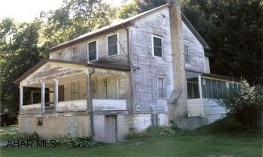 Country Home, very cozy inside, just needs siding. 3+/- survey being done. Country Home, 2-story with attic walk-up for storage. Main level laundry, sitting area off kitchen, hardwood floors under carpet, woodstove in kitchen. Part of property adjoins Yellow Creek.