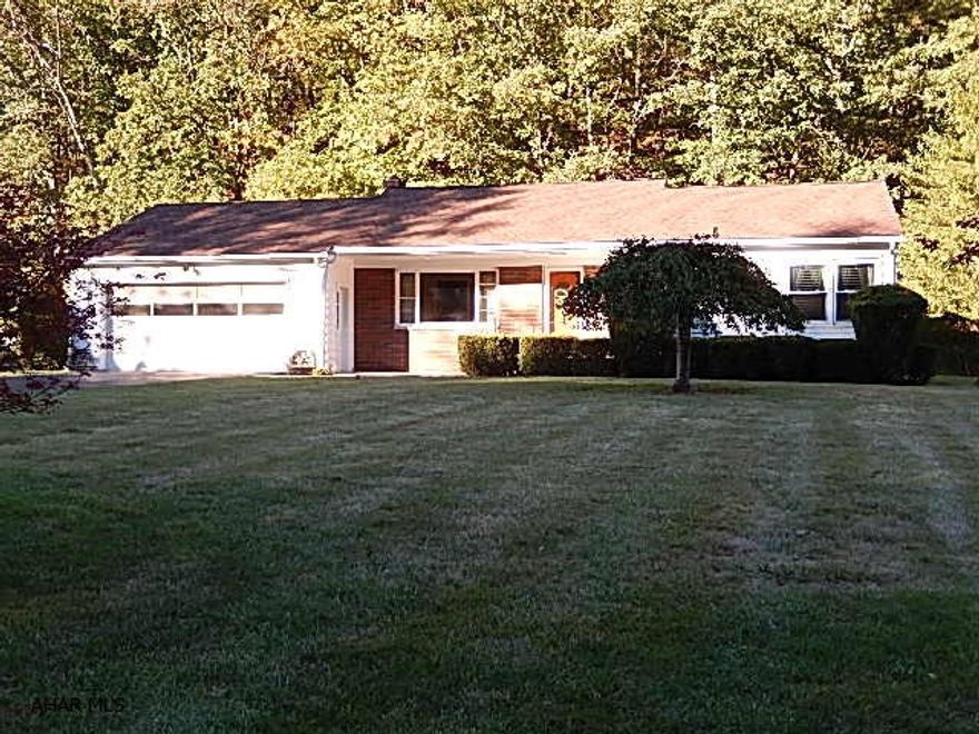 Beautiful ranch home on spacious lot. Paved driveway, hardwood floors, master bedroom, full basement partially finished. Updated windows. Large deck. 2 car garage. Call today!