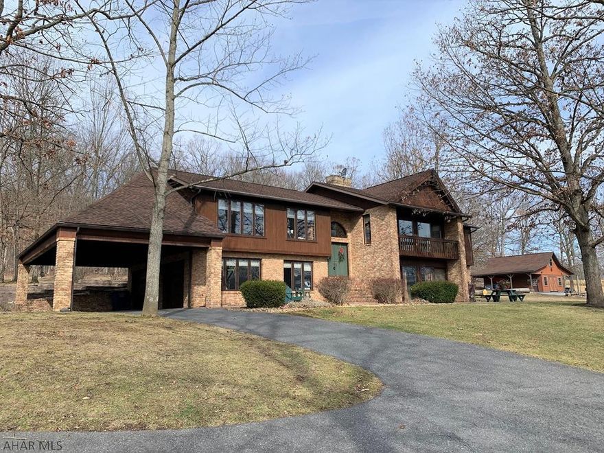 Check out this spacious custom brick and cedar home!! Features galore! Double door entry foyer; living room w/ see through dual view FP; kit. w/ custom cherry cabinets & island; dining area w/ FP; gracious master suite with bath & walk-in closet; two additional bedrooms; & a full bath. Lower level has a large family room w/ brick hearth FP; laundry room w/ half bath; & bonus room w/ kitchenette. Solid panel wood doors throughout; wood trim; recessed lighting; & large windows. Front deck; front & rear patios; & rear covered porch. 2-car integral garage (finished); 2-car carport; & large barn or garage w/ loft (insulated). Resting on 2.36 acres with a beautiful spring fed pond. Super location just minutes to town and major roads. Hang at the firepit while enjoying gorgeous mountain views!!!