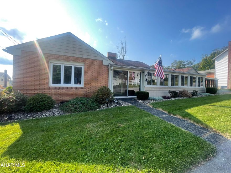 Well maintained ranch home in Gallitzin Borough on .33 acre. Drive onto the paved driveway that enter into the 2 seperate garages. Access the home through the 3 seasons room perfect for a mud room and bug free relaxing on those cool nights.  Walking through the front door is an entry way with coat closet. The inviting stone fireplace in the spacious living room is great for keeping warm. The kitchen looks through to the dining room and has a bump out for a pantry area or breakfast nook.  The hallway off the living room leads to the three bedrooms and full bath. The primary bedroom has a half bath for privacy. The basement is finished family room with fireplace. 3/4 bath and bonus room. Storage and laundry room with utility sink. Central Air! The basement door leads to the 16 x 32 deck. 2 raised garden beds. Vinyl fence for privacy. Solar lights light the way for entertaining in the yard.