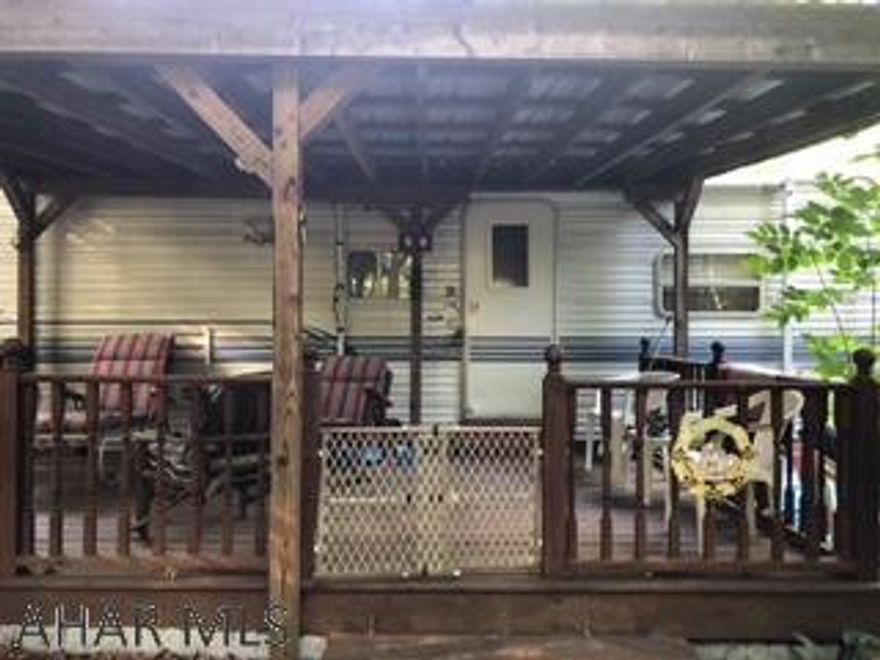 30 feet Nomad camper, land included, with covered deck.  Has a covered bridge with stream.  Has all amenities of Glendale Yearound.  Needs some TLC