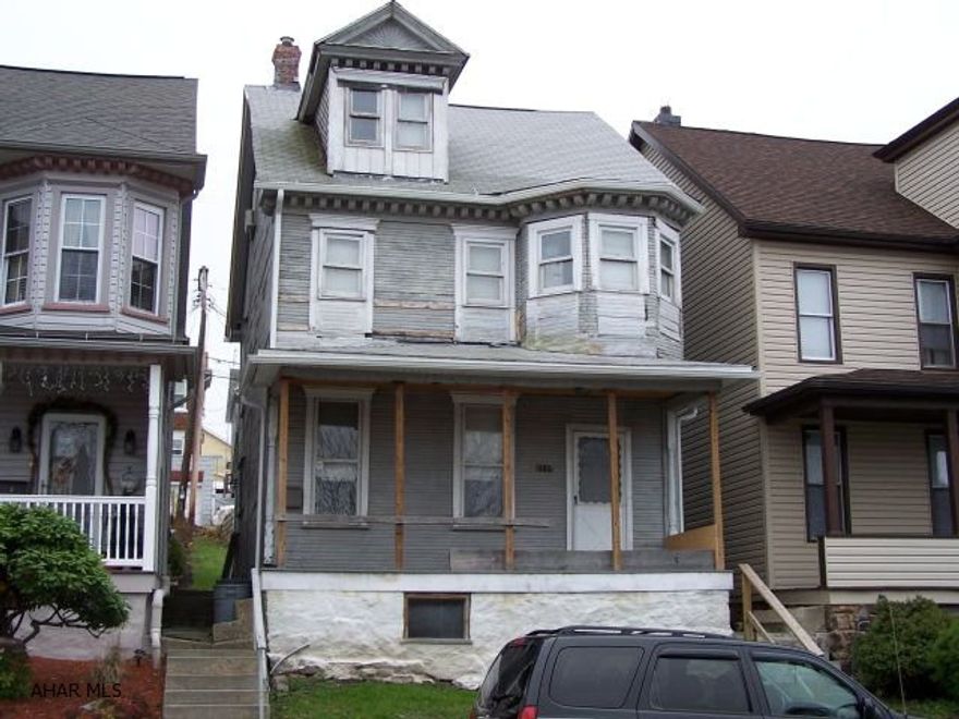 This 2-3 bedroom 2-story home has potential. The house to the left has the exact same look except that it has been updated. Wow - what a difference. Check it out to see how beautiful this home could be with some updating. New roof in 2005. Parking pad behind house.