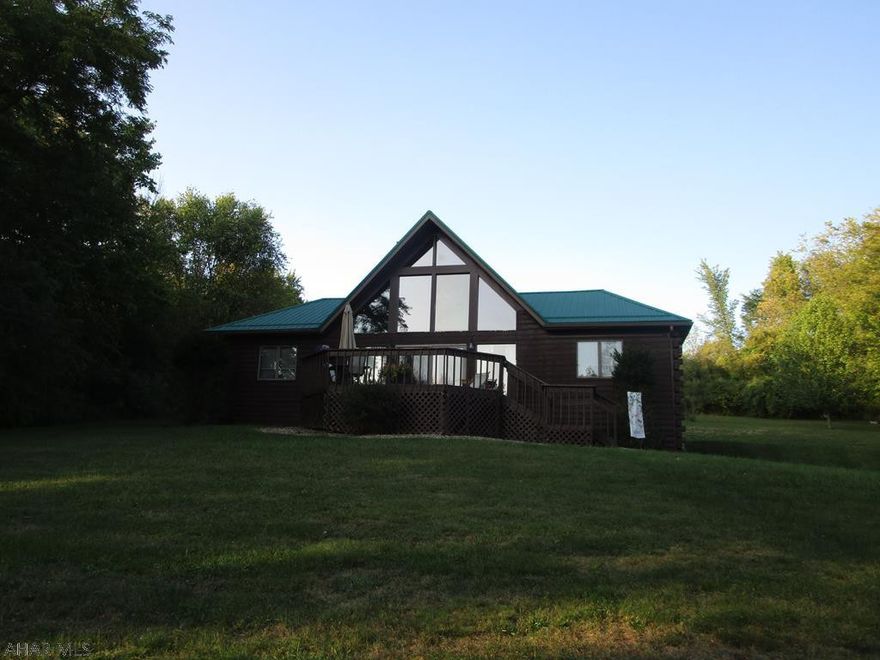 Nice rural location near Prince Gallitzin State Park. 1.5 story log sided home features 2 bedrooms and 2 baths on the first floor and a loft on the second floor that could be used as a family room or 3rd bedroom. Master bath includes a jet tub.  Large windows in the living room show off the nice view. Partial basement with one car garage and a detached two car garage with second floor workshop. Additional storage building on site.