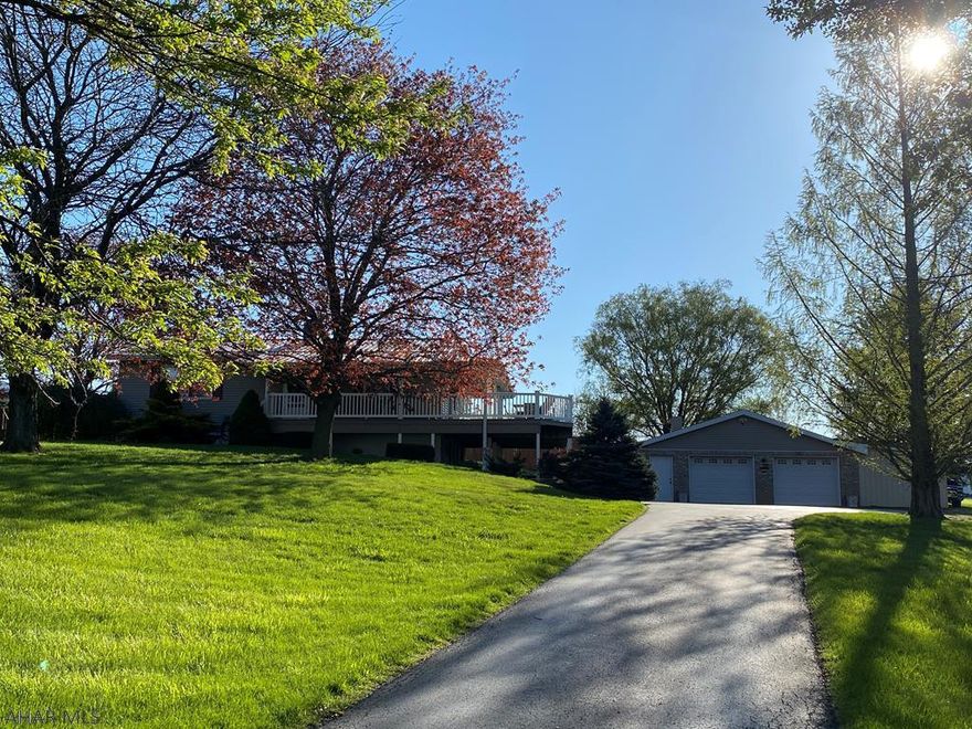Beautiful Ranch home sits on 1.9 acers.  This home offers an open floor plan with vaulted hard wood ceilings,   Beautiful brick propane fire place in the living room.  Sliding door in living room leads to large wrap around trex deck with views for miles.   Finished basement that has rooms for 2 more bedrooms.  Large family room with wood burning stove. Basement doors leads to coved patio.  Home also has stamped concrete patio and fire pit out back.  Large two car garage with electric and water.  Large side yard for all your outdoor fun!!