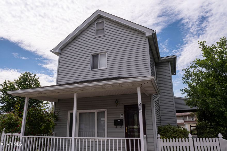 Step into this beautifully maintained two-story home offering 1,600 square feet of comfortable living space on a double corner fenced lot measuring 0.13 acres. This charming residence features three bedrooms and one updated bathroom, making it an ideal choice for those seeking both character and functionality. Upon entry, you'll be drawn to the inviting layout that flows seamlessly into a timeless kitchen, complete with rich cherry cabinetry, stainless steel appliances, ample counter space, a center island, and a breakfast bar- perfect for everyday living and entertaining. Upstairs, you'll find the three spacious bedrooms and the updated full bath. The attic provides excellent storage, while the clean, dry basement adds even more usable space. A new furnace was installed in 2020 for added comfort and efficiency. Outside, the expansive covered porch - featuring a half-vaulted ceiling and cable hookup - feels like an additional room, perfect for relaxing or entertaining. The fenced yard includes two paved off-street parking spaces and a storage shed. As summer arrives, enjoy the simple pleasures of your own apple and cherry trees, along with raspberry bushes, turning your backyard into a private seasonal retreat. check out our Matterport 3D virtual tour and schedule your showing today!