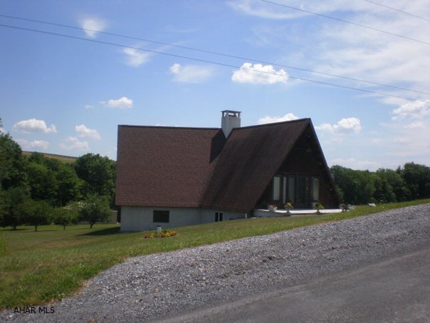 Large A-Frame in nice country setting. Home has approx 2218 Sq Ft on 1st floor. Quality construction with some finish needed. Large pole garage near rear of site was used for ultralight storage.