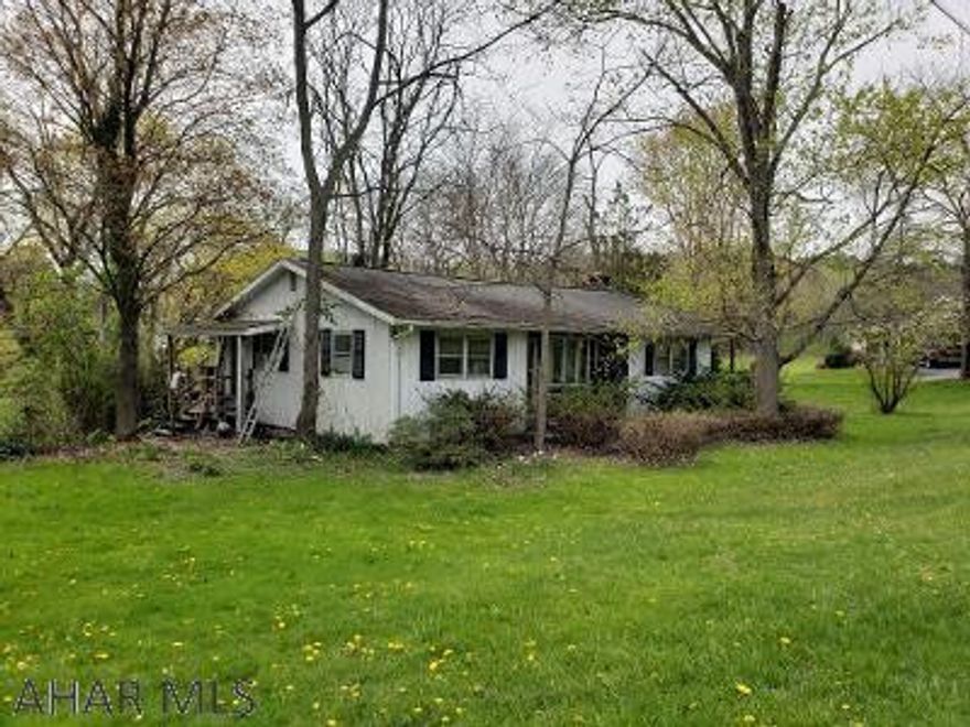 This 3-bedroom 1-bath home is waiting for your vision and creativity!  Features include Sunroom with vaulted ceiling & propane fireplace, nice back deck & small stream on .59 acres in Spring Cove School District. J-535