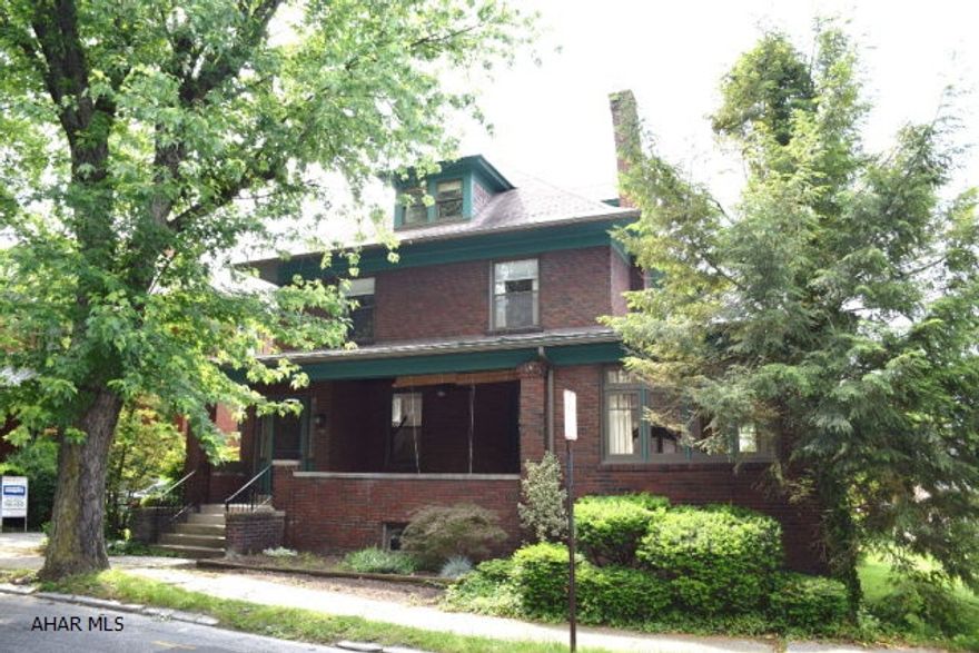 HIGHLY MOTIVATED SELLER!! This is the quintessential Hollidaysburg brick home that everyone wants.  There is so much character and charm inside these brick walls.  Beautiful hardwood floors,  brick fireplaces, window seats, leaded glass windows, pocket doors, and cute second floor covered porch.  Modern Ikea kitchen with pantry and breakfast bar.  Large, bright sunroom with so many possibilities.  Large bedroom suite on third floor with pretty views of the borough. Off street parking.  Large rear deck.   Recent painting with decorator grey in kitchen and dining room gives the interior  an updated and modern look. Only one block to the downtown Hollidaysburg Diamond and all of the great activities this vibrant community has to offer.  You will be so comfortable in this home!