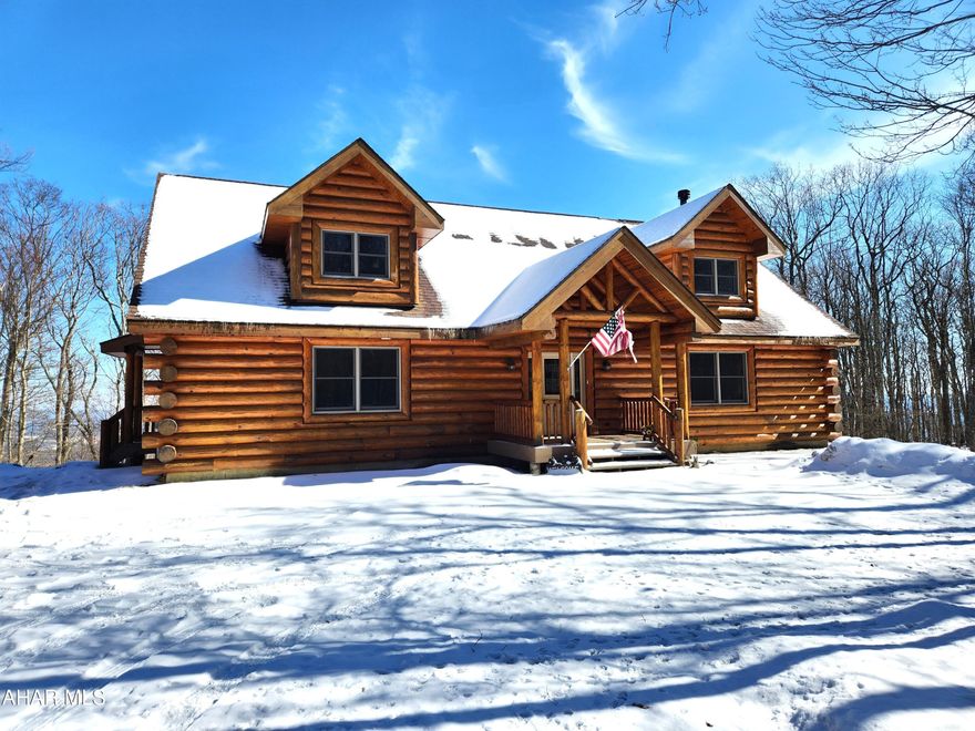 Are you looking for seclusion and breathtaking views?  Then come take a look at this impeccably maintained log home that exudes rustic charm and modern comfort in equal measure.  Standing on top of the Allegheny Highlands Plateau against a backdrop of magnificent views, the home offers a seamless blend of natural beauty and serene seclusion.  Upon arrival, the sturdy log construction catches the eye, with its warm, honey-colored wood complimented by the three-car log-sided detached garage.  The main living areas are designed for both relaxation and entertainment, featuring a stone, wood fireplace as the centerpiece of the open concept living and dining rooms.  The kitchen features oak cabinets with a breakfast bar.  The master suite, with an en suite bathroom, on the first floor provides the perfect scenario for those who prefer one floor living.  The mud room is spacious and includes a doggy shower.  The laundry room features a utility tub and lots of storage space.  The open concept second level contains an office area, two bedrooms and a 3/4 bathroom.  The basement features ICF cocrete walls and could readily be finished to suit you.  Sitting on the back porch, Shawnee Lake is visible in the magnificent view and it is a great place to enjoy your morning coffee or entertain friends and family.  Come take a look, it may be just what you've been looking for.  The property is located in the Folmont Property Owner's Association.  The benefits include road maintenance, garbage service, fishing ponds, walking/hiking trails and community activities.  Located close to Shawnee State Park, Indian Lake, Lake Stoneycreek and a short drive to Seven Springs and Hidden Valley, this property offers easy access to all that Bedford and Somerset counties have to offer.  It is approximately 1-1/2 hours from Pittsburgh and 3 hours from Washington DC and Baltimore. Buyer to verify acreage and square footage.  24 hour notice required for showings.