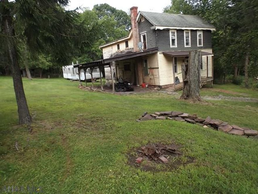 Home needs alot of TLC and would need a rehab loan.  New OFA furnace.  Well and septic onsite.  Mobile home is gutted and was used for workshop.  Beautiful acreage in great location in Sinking Valley.