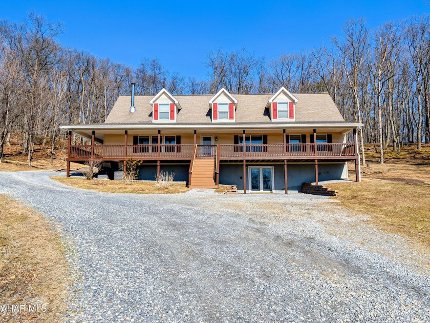 Escape to your own private mountain retreat on 10+ acres just minutes from Raystown Lake. This custom-built 5-bedroom, 4.5-bath home combines seclusion with convenience, located only 1 mile from Weaver Falls Boat Launch. The main level features three bedrooms and 2.5 baths, along with an open kitchen and dining area, a cozy living room with wood stove, family room, and laundry. Upstairs offers two additional bedrooms, a ¾ bath, and a spacious open area ideal for an office, studio, or extra sleeping space, plus access to a large deck. The finished walk-out basement includes a kitchenette, bonus room suitable for a bedroom, ¾ bath, expansive recreation area, and mechanical/storage room. Outdoors, enjoy a large covered porch, composite deck, covered carport, swim spa with concrete patio, tractor shed/barn, wood and garden sheds, garden, fruit trees, small pond, and fire ring perfect for relaxing or entertaining in a peaceful natural setting.