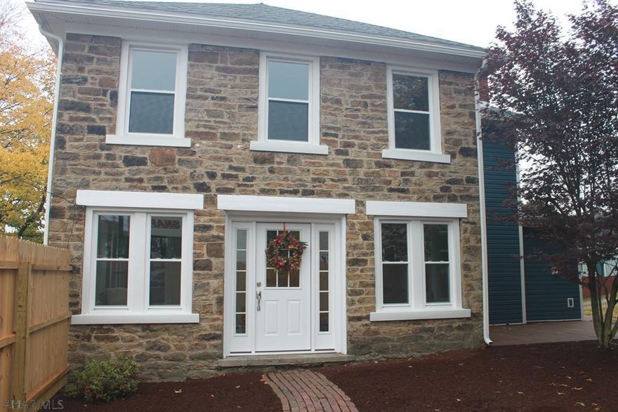 This gorgeous historic home is newly remodeled for modern convenience with a timeless aesthetic. The hand-hewn beams and original stonework and wood floors in the home give way to spacious, open living areas with plenty of natural light. Yard is landscaped and has plenty of room. Off-street parking, first floor laundry and brand new appliances. Property includes a large .4 acre lot, with part of it fenced. Living room has built in nook for your electronics with electric and easy access for a wall mounted tv, a convenient and beautiful feature! Don't wait to see it, this historic home is like no other! New windows, roof, drywall, floors, electric, and much more.