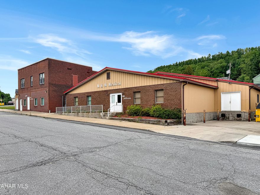 Exceptional opportunity to own approximately 12,000 square feet of versatile mixed-use space in Summerhill Township. With no zoning restrictions, the possibilities are virtually endless for investors, business owners, and entrepreneurs alike. Most recently utilized as a medical equipment repair facility, this property is well-equipped to accommodate a wide range of uses including office, manufacturing, warehouse, distribution, service-based businesses, and more. The main building offers a functional layout featuring multiple offices, expansive open work areas, a lunchroom, and additional flexible spaces to suit a variety of operational needs. A connecting corridor leads to the adjoining building, providing even more open and adaptable square footage. Above the second building is a spacious 3-bedroom, 1-bathroom apartment currently occupied by a long-term tenant, offering an additional income stream. Situated on a prominent corner location, the property includes four tax parcels totaling approximately 0.60 acres, providing ample room for parking, future expansion, outdoor storage, or redevelopment opportunities. Notable features include 3-phase power, a loading dock, newer metal and rubber roofing systems, a heat pump, and much more. Whether you're looking to expand an existing business, start a new venture, or add a unique investment property to your portfolio, this versatile property offers tremendous potential. Call today for more information or to schedule your private tour!