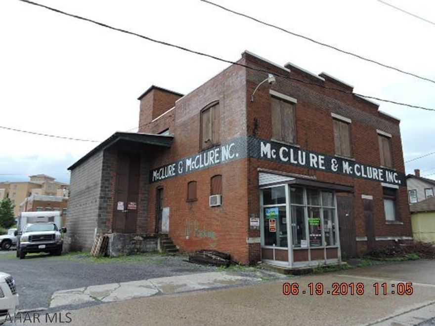 Large warehouse with office space.  Zoned light industrial. Finished basement, freight elevator, and loading dock.  Electric baseboard in first floor retail area.  As Is Sale.