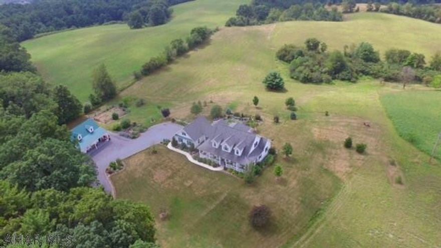 Get that southern plantation feeling immediately upon arrival of this impressive custom built home with 13.83 acres. The private secluded setting captures stunning panoramic views from every vantage point. 3 Car garage plus horse stables or carriage house add to the appeal. Entertain guest in the impressive great room that overlooks the professionally landscaped backyard oasis or relax on the huge wrap around covered porch. ULTIMATE SERENITY! Open floor plan, main floor master suite and laundry room are just a few of the many attributes this home has to offer.