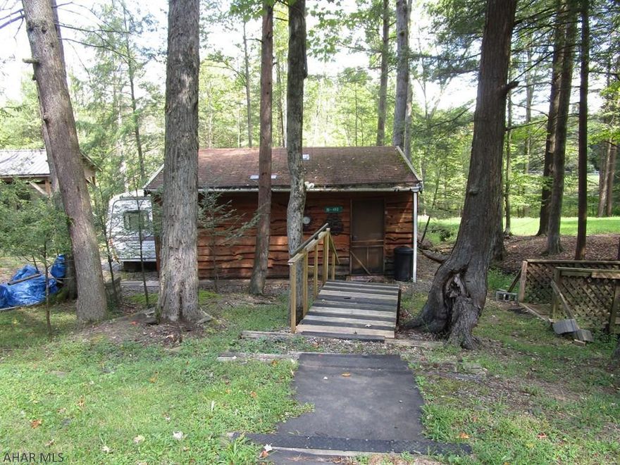 50' x 100' campsite with covered camper and addition.  Camper being sold as is.  Private in the rear of lot.  Sewer is available but has to be connected to the system.  New furnace installed last year.  Shed.  Make an offer.