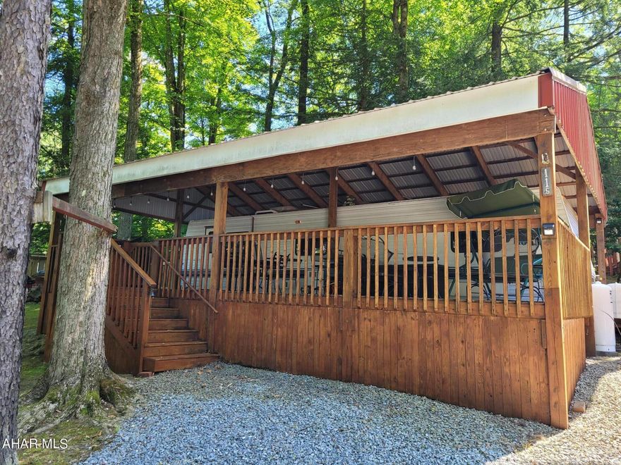 It is all about this great deck!  12' x 35' covered deck allows your whole family to enjoy the outdoors together.  That is what camping is about.  Or gather under the pavilion next to the fire pit for a bonfire and some smores.  There is a small back deck with a ramp access.  The camper slideout offers more room inside as well.