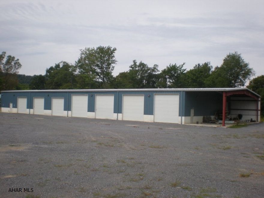 2 garage/storage buildings. 1 is 70 x 180 metal building on a concrete slab, 20'ceiling height. The other is a 54x36 metal garage with three overhead doors.