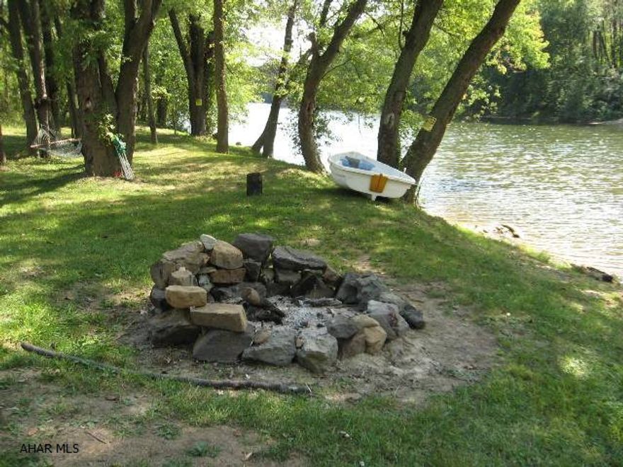 Enjoy this 10+ acres and unique setting with hard-to-find frontage along the Juniata River and only minutes from downtown Bedford.  This is the ideal place to camp, hang your hammock, fish and launch your boat, kayak or canoe.  Property has an area to park your RV with electric hookup.  Shed with electric service included in this sale.