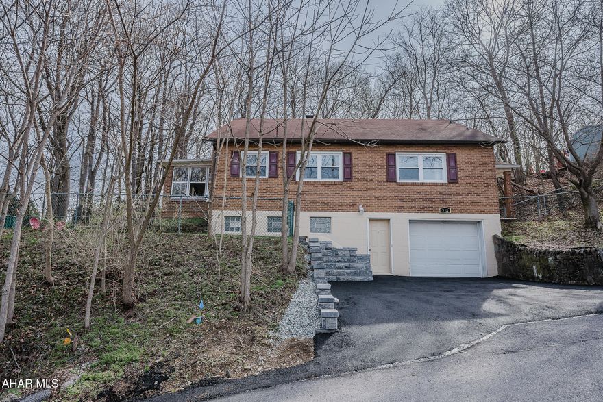 Find peace and tranquility waking up to the sound of birds on a summer morning.  This home is backed by woods on a low-traffic street, and is still only minutes from town.  The open floorplan provides wonderful options from the eat-in kitchen, whether you're entertaining in the living room or out on the enclosed porch next to the side-yard with a firepit.  Exposed hardwood floors were recently refinished and more can be found under the carpets.  There's even a cedar closet in the bedroom.  The second floor includes a spacious open area ready for your imagination!  It has an integral garage, a 2-car paved driveway with new retaining wall, and fenced-in yards.  Call today for a tour and get ready to make this your first, next, or last home.