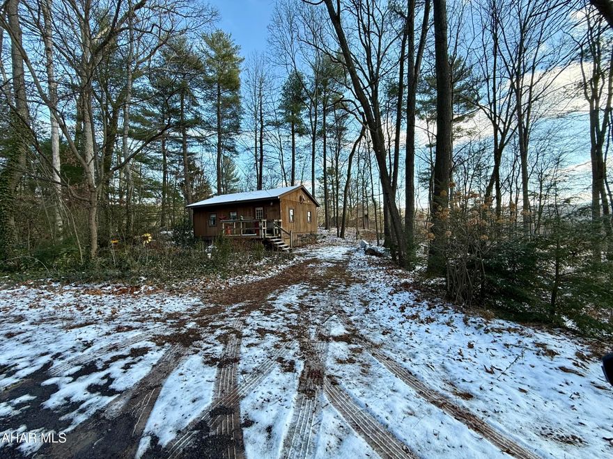 Escape to your own private retreat in Breezewood Park! This charming 2-bedroom, 3/4-bath ranch cabin sits on 1.08 wooded acres. Whether you're looking for a weekend getaway or a cozy year-round home, this property delivers the peace, privacy, and outdoor living you've been dreaming of.

Step inside to find warm cabin touches throughout, an inviting open layout, and plenty of natural light. Enjoy morning coffee on the porch, evenings by the firepit, and endless room to explore your own little slice of nature. With easy access to town and nearby outdoor recreation, this cabin is your gateway to relaxation and adventure.

Properties like this don't come along often—don't miss your chance to make this Breezewood Park hideaway your own!