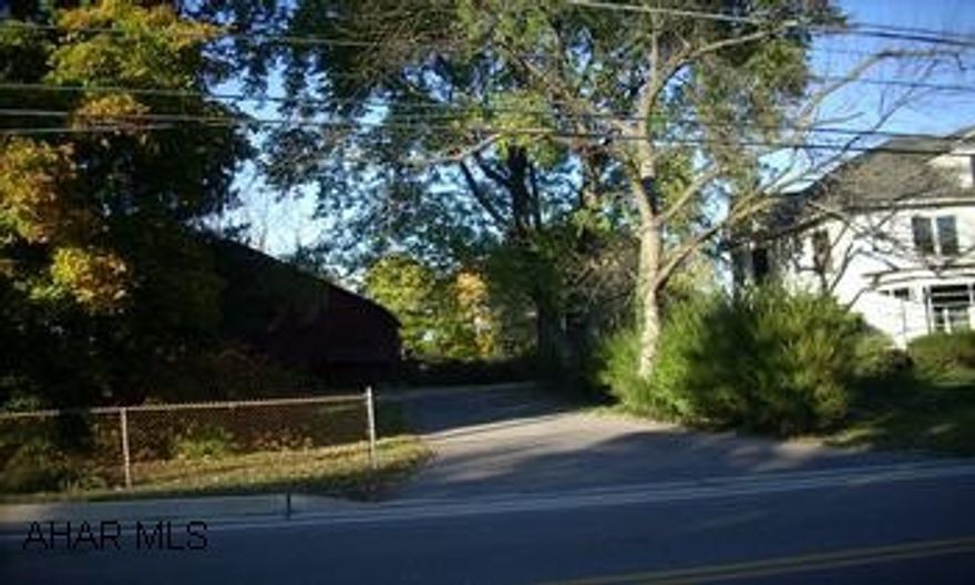OLDER TWO STORY FRAME HOUSE ON RIGHT W/ IC. INTE GARAGE W/ 8 ACRES. LARGE OLDER HOME-GOOD MECHANICS BUT INTERIOR NEEDS REMODELED, NO ZONING, GOOD OPPORTUNITY, FOR A COMMERCIAL USE OR RES. DEVELOPMENT, 8 ACRES W/ SEWER AND WATER.