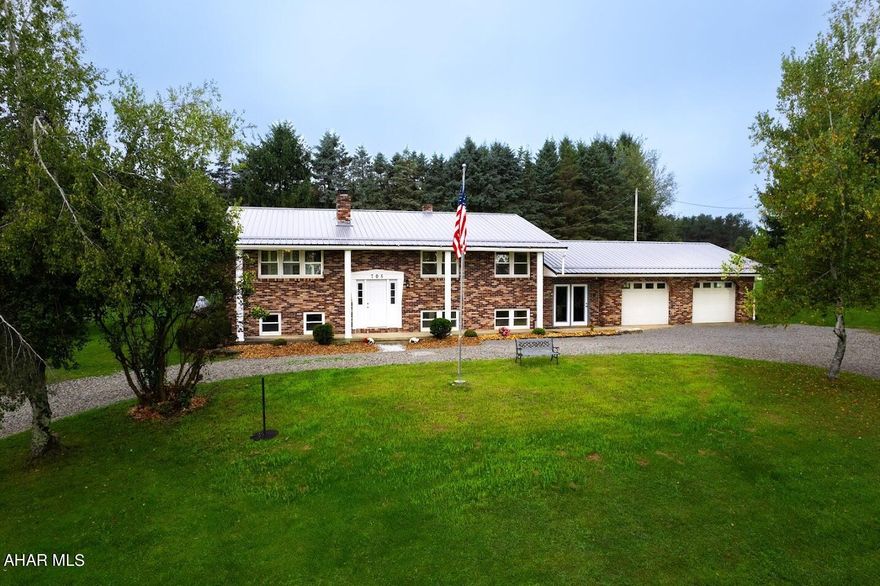 Beautifully well maintained home with many  updates!! The oak woodwork throughout the home is absolutely breathtaking and makes a huge impression to the eye!! As you enter the front entrance the foyer is accented with a lovely brick wall and wood crown molding.  The open living/dining room area offers a stone, gas fireplace to accent the woodwork on the walls and floor.  Large spacious kitchen with plenty of cabinetry, ceramic tile countertops and flooring, pantry and breakfast bar. The master bedroom with 1/2 bath and the woodwork though out both rooms. Fully renovated full bath and refinished floors in bedrooms. The rustic family room is unique with barn wood walls and a stone wood burning fireplace. Lower level  their is a new full bath/shower and LP flooring and 2 more bedroom and laundry room adjacent.  Added feature is  a breezeway off the 2 car garage.  Large private back deck for relaxing and enjoying the wildlife.  The circular driveway is a nice added feature upon entering the home!   A Must See!!!