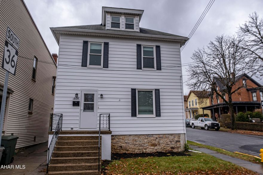 Welcome to modern comfort and classic charm in Hollidaysburg Borough! This 3-bed home is meticulously remodeled, featuring a dream kitchen with new appliances. The living spaces are open and inviting with fresh flooring. The finished attic adds versatility. Enjoy year-round comfort with the addition of AC split units for both floors. The exterior and interior are freshly painted, with new blinds and fixtures. Off-street parking adds convenience. Located close to downtown activities, parades, festivals, farmers market, shops, and restaurants. Your dream home is waiting!