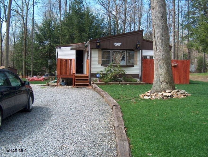 Great get-away or hunting camp. Single wide MH with add on. Enclosed front porch & shed