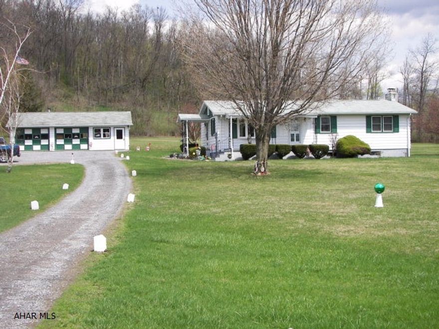 This 3 BR, 1 BA house has a new roof (2013), new windows, and hardwood flooring under the carpet. The unfinished basement with its wood fireplace could be made into a family room. The detached oil fuel heated 2 car 36' x 26' garage is great for a workshop or business. There is also a 2BR 1BA mobile home on the property which is rented to a good tenant, and who would like to stay. If you want to have horses there is also a two story 30' x 22' Barn that can make your dream a reality. Call today for a showing!