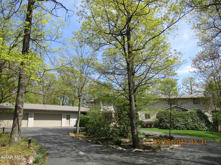 Uniquely designed and meticulously maintained, this special home rests on over five acres of wooded land - THE GLADES.   From the elegant yet welcoming foyer the first floor features spacious living, dining rooms, eat in kitchen with sub-zero refrigerator/freezer and other professional quality appliances, private den/office and huge owners suite featuring ensuite bath with a steam shower, two walk in dressing rooms.  Main floor exercise room, pantry, laundry room, swim spa, and so much more!  The second floor features four bedrooms, bathrooms and ample storage rooms.   The full basement includes exterior access and features a huge entertainment area and a bedroom with its own bath.   The home features three heating and cooling systems for perfect comfort year round.    Enjoy the peace and quiet of mountaintop living from the sun room or patio.  Wildlife abounds in the surrounding woods - whitetail deer, turkey, even a bear or two!   The  four car garage is heated and accessed from the gently sloped circular drive.  New windows throughout the home and three-year old roof.