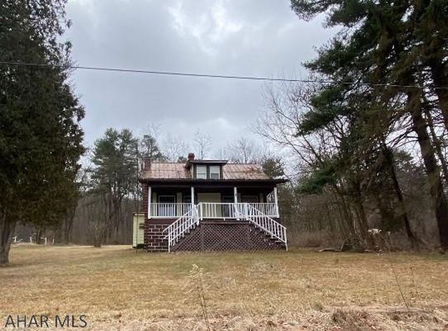 Cape Cod on 4.8 acres with 2 garages. Large 3 bay garage in good condition that was once used as an inspection station and tire shop and 1 smaller garage with 1 garage door. Home has 3 bedrooms and bath. House needs TLC. Selling AS IS.