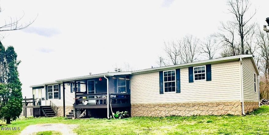 Welcome to this beautiful 11 plus acre property in the Penn Cambria School District. This doublewide mobile home offers serenity with beautiful views from the enclosed deck space or the outdoor deck space. The home offers a large living room with stone fireplace. Open concept kitchen with bar/island and breakfast nook. This home also offers a 2nd living room or use as a formal dining room. Primary bedroom offers a walk-in closet and ensuite with large closet, dual vanity and walk in shower. The 2nd bedroom offers large windows and closet space. The 2nd bath offers a tub/shower combo, and closet storage. There is a third room that could be an office. The closet in that room is housing the water treatment. Outside, there is a large barn for horses, a 2nd barn and a chicken coop. Some of the acreage is fenced close to the house to keep the dogs in and close. There is a stream and pond on the property at the bottom of the hill. Very private property again, with amazing views. Call to see this special place today!