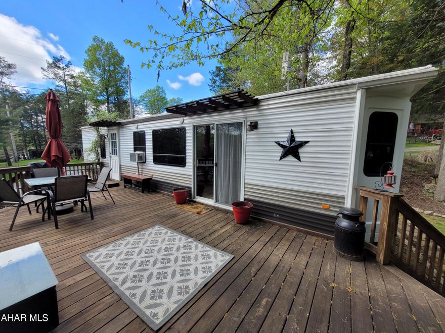 With all the comforts of home you can live in this upgraded unit or enjoy weekends glamping.  The owners have added special touches for both functionality and relaxation.  
With a 100A. service in both the camper and the shed you will never be short on power.  A 30 gallon water heater means plenty of hot water for all.  The water line is buried allowing you to use the property year round with proper care.  Dual heat sources of propane hot air and electric baseboard gives you a choice of heating as well as more than enough on those chilly nights.  Central air as well as a window air conditioner keeps everyone cool.  A full size refrigerator and stove allows you to satisfy the hungry.  No need to haul dirty clothes home when you have a stackable washer and dryer in the shed.
The sellers upgraded the flooring.  They also installed new upper cabinets, a regular commode and had metal roofs installed over the slideouts to protect them from the weather.  
Relax on the swing and admire the landscaping.  The furniture both inside and out stay with the camper.  The Weber grill is directly piped to the main propane tank.  Sit on the porch or make smores next to the fire pit.  
The 10' x 24' shed has room for toys and tools, some of which the seller is leaving.  
You  truly need to experience this property in person.  Make an appointment today.