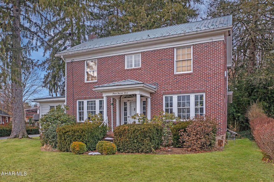 3-bedroom, 1.5-bathroom Federal-style brick home in Tyrone with distinctive features. Highlights include a spindle hardwood staircase with a carpet runner, original hardwood floors, and a fireplace with a removable insert, and large windows providing ample natural light. The main level includes a convenient half bath. The property offers two detached garages and a private drive. Explore the Matterport 3D virtual tour and schedule a showing today.